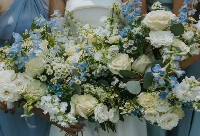 Westside Flowers wedding bouquets featuring white and blue flowers in a garden cottage style.