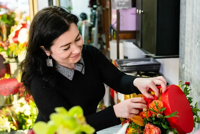 Valley Village Florist owner assembling a floral arrangement